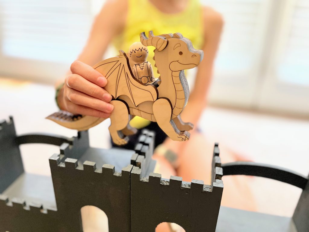 Dragon and rider peg doll set being played with by a kid